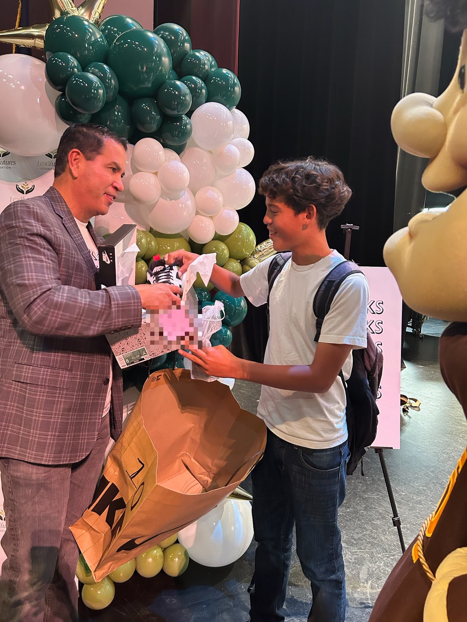 A student receiving new shoes at an EVOKicks celebration